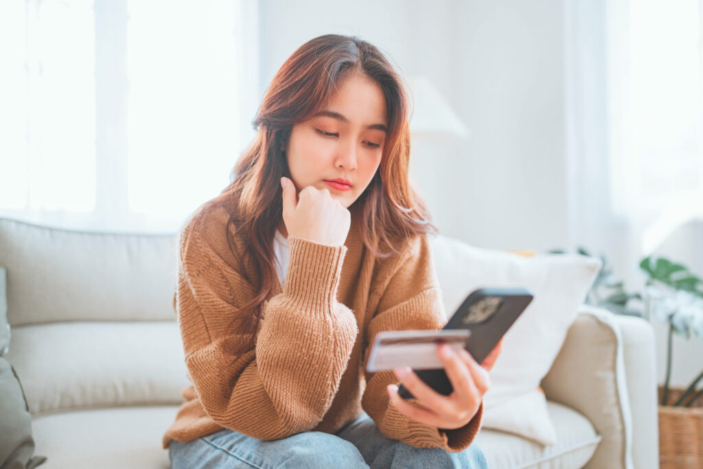 woman-looking-at-phone-bills